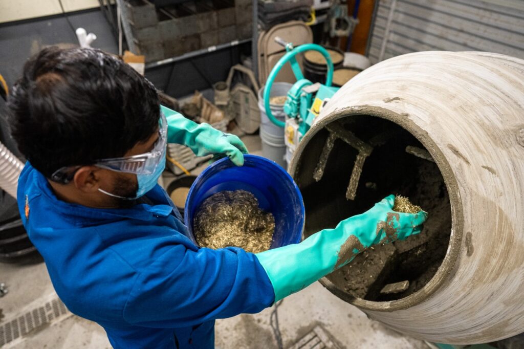 Researcher adding SCM to cement mixer